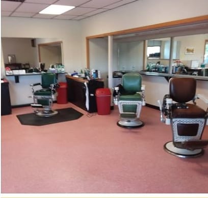 The shop floor at Toby's with three antique barber chairs and wall mirrors